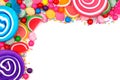 Top corner border of assorted colorful candies over white Royalty Free Stock Photo