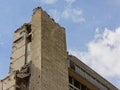 Top corner of a stripped down, half demolished apartment building in rabot niehgborhood, Ghent