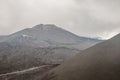 Top of crater Mount Etna volcano, frozen cold lava smokes, thick clouds Royalty Free Stock Photo