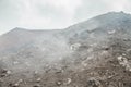 Top of crater Mount Etna volcano, frozen cold lava smokes, thick clouds Royalty Free Stock Photo