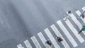 the From the top crosswise view of people walk on street pedestrian crossroad in the city street ,bird eye view.