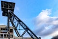 Top of disused shaft tower of former Waterschei coal mine against blue sky