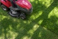 Top down above view of professional lawn mower worker cutting fresh green grass with landcaping tractor equipment Royalty Free Stock Photo