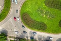 Top down aerial view of busy street roundabout intersection with moving cars traffic