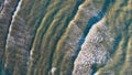 Top-down aerial view of a clean white sandy beach on the shores of a beautiful turquoise sea Royalty Free Stock Photo