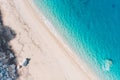 Top-down aerial view of a white sandy beach on the shores of a beautiful turquoise sea. Royalty Free Stock Photo