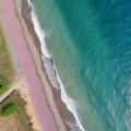 Top-down aerial view of a clean pink sandy beach on the shores of a beautiful turquoise sea. generative ai Royalty Free Stock Photo