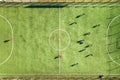 Top down aerial view of green football sports field and players playing football. Drone taken image of small unrecognizable Royalty Free Stock Photo