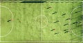 Top down aerial view of green football sports field and players playing football. Drone taken image of small unrecognizable Royalty Free Stock Photo