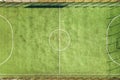 Top down aerial view of green football sports field and players playing football. Drone taken image of small unrecognizable Royalty Free Stock Photo
