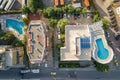 Top down aerial view of hotels roofs, streets with parked cars and swimming pools with blue water in resort city near the sea Royalty Free Stock Photo