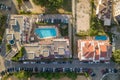 Top down aerial view of hotels roofs, streets with parked cars and swimming pools with blue water in resort city near the sea Royalty Free Stock Photo