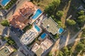 Top down aerial view of hotels roofs, streets with parked cars and swimming pools with blue water in resort city near the sea Royalty Free Stock Photo