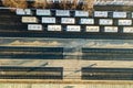 Top down aerial view of many cargo train cars on railway tracks