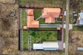 Top down aerial view of a private house with red tiled roof and frame structure prepared for installation of solar panels Royalty Free Stock Photo