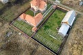 Top down aerial view of a private house with red tiled roof and frame structure prepared for installation of solar panels Royalty Free Stock Photo