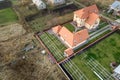 Top down aerial view of a private house with red tiled roof and frame structure prepared for installation of solar panels Royalty Free Stock Photo