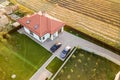 Top down aerial view of a private house with red tiled roof and spacious yard with parked two new cars Royalty Free Stock Photo