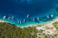 Top down aerial view of sailing boats docked in blue bay of Fiskardo, Kefalonia island, Ionian, Greece Royalty Free Stock Photo