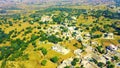 Top down aerial view of small houses in sunny weather with grassy fields and roads , trafficin mIrpur Azad Kahsmir, Pakistan