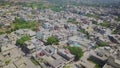 Top down aerial view of small houses in sunny weather and roads , traffic in Azad Kahsmir, Pakista