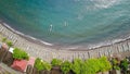 Top down aerial view of traditional Indonesian fishing boats called jukung on black sand beach. In Amed, Bali, Indonesia