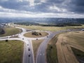 Top down aerial view of a traffic roundabout on a main road