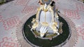 Top down aerial view of a traffic roundabout on a main road in an urban area