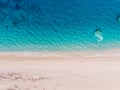 Top-down aerial view of a white sandy beach on the shores of a beautiful turquoise sea. Royalty Free Stock Photo