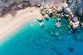 Top-down aerial view of a white sandy beach on the shores of a beautiful turquoise sea. Royalty Free Stock Photo