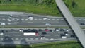 TOP DOWN: Cars and trucks drive through a congestion forming under the overpass.