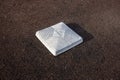 Top down, close up view of a base on a clean baseball field on a bright, sunny day Royalty Free Stock Photo