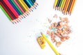 Top-down of the Colored pencils and pencil shavings along with yellow pencil frog on a white background. Multi-colored pencils wit Royalty Free Stock Photo