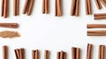 Top-down composition of cinnamon sticks framing white space with soft lighting, flat lay Royalty Free Stock Photo