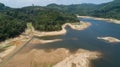 Top down of Dam lake mountains with forest green pattern beautiful sunny day summer weather Drone shot aerial view clouds Royalty Free Stock Photo