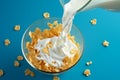 Top down delight Corn flakes with milk on a blue background