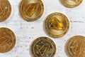 Top down detailed view, golden commemorative EOS - EOSIO cryptocurrency - coins on white stone board