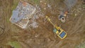 TOP DOWN: Excavator helps worker burn scraps while rebuilding an old farm.