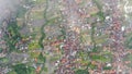 Top down from height over light clouds to a residential area along Jalan Pantai Batu Mejan Road in Canggu, Bali