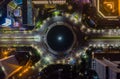 Top down overhead aerial view of moving car traffic at roundabout Vehicle road traffic around Selamat Datang monument in