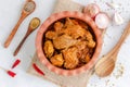 Spicy Indian Chicken Curry Garnished with Red Chili Peppers, Cilantro, Onion and Spices Top Down Flat Lay Photo Royalty Free Stock Photo