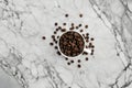 A top-down photograph captures the captivating sight of coffee beans scattered on a marble white
