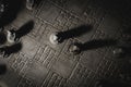A top down portrait of the beginning of a game of chess. The chessboard and the pieces are made of stone and represent sculptures Royalty Free Stock Photo