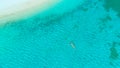 TOP DOWN: Relaxed young woman cooling off by floating in the turquoise ocean.