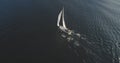 Top down of sail yacht. Aerial sailboat regatta under sails at open sea. Racing ship at seascape Royalty Free Stock Photo