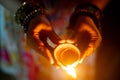 Top down shot of hand holding diya oil lamp in heart shape spread love and joy on the hindu festival of diwali Royalty Free Stock Photo