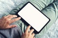 A top-down shot of a long sitting man with a digital tablet on his legs. Man on a sofa starts working on an empty Royalty Free Stock Photo