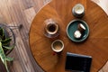 A top down shot of modern living room coffee table with a coffee cup, book, tablet, and a muffin on it. Royalty Free Stock Photo