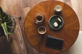A top down shot of modern living room coffee table with a coffee cup, book, tablet, and a muffin on it. Royalty Free Stock Photo