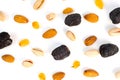 A top-down shot shows a variety of nuts and dried fruit scattered on a white background Royalty Free Stock Photo